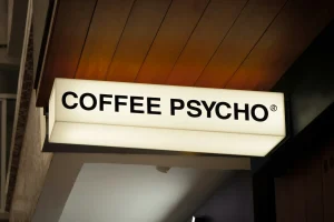 שלט מואר עם הכיתוב "COFFEE PSYCHO", מתאים לשילוט לעסק בתחום הקפה.